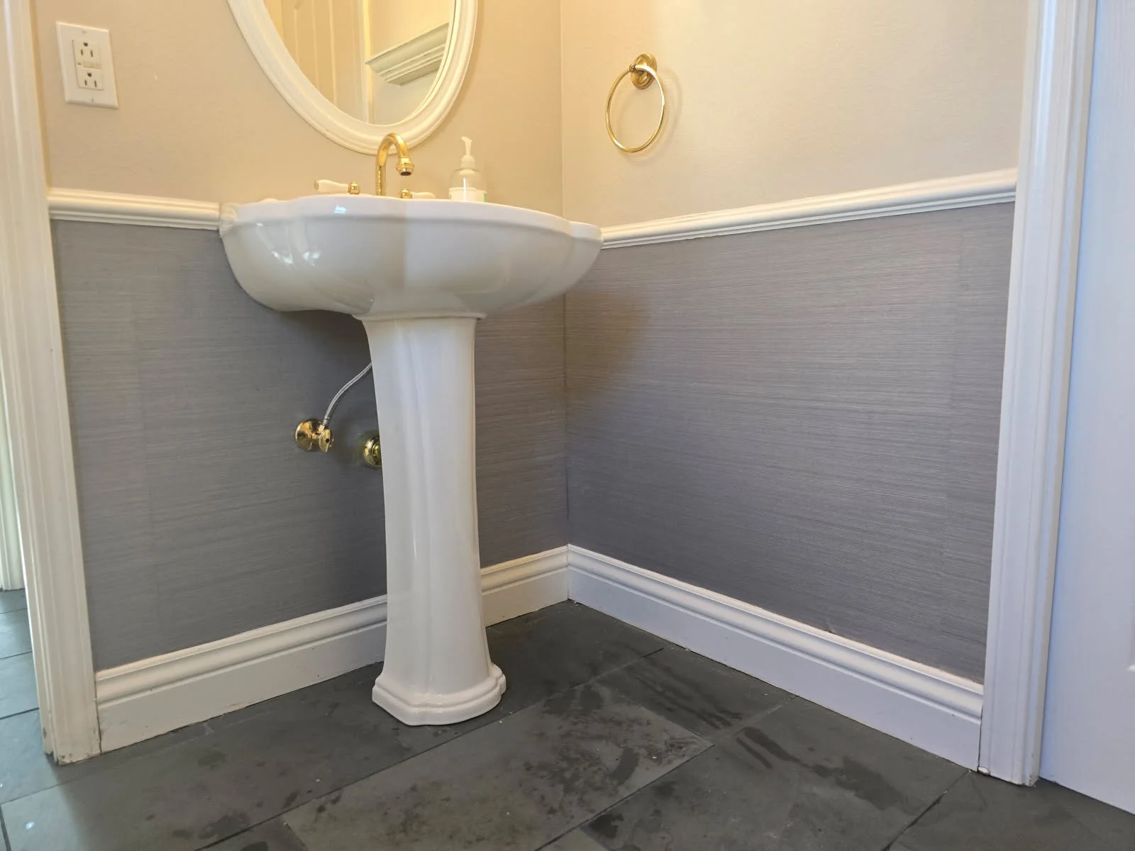 Master wallpaper installer aligning patterned wallcovering
