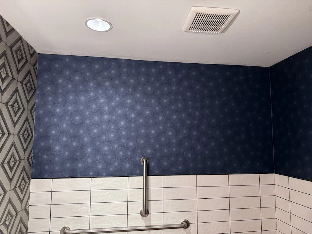 Dining room with classic patterned wallpaper installation