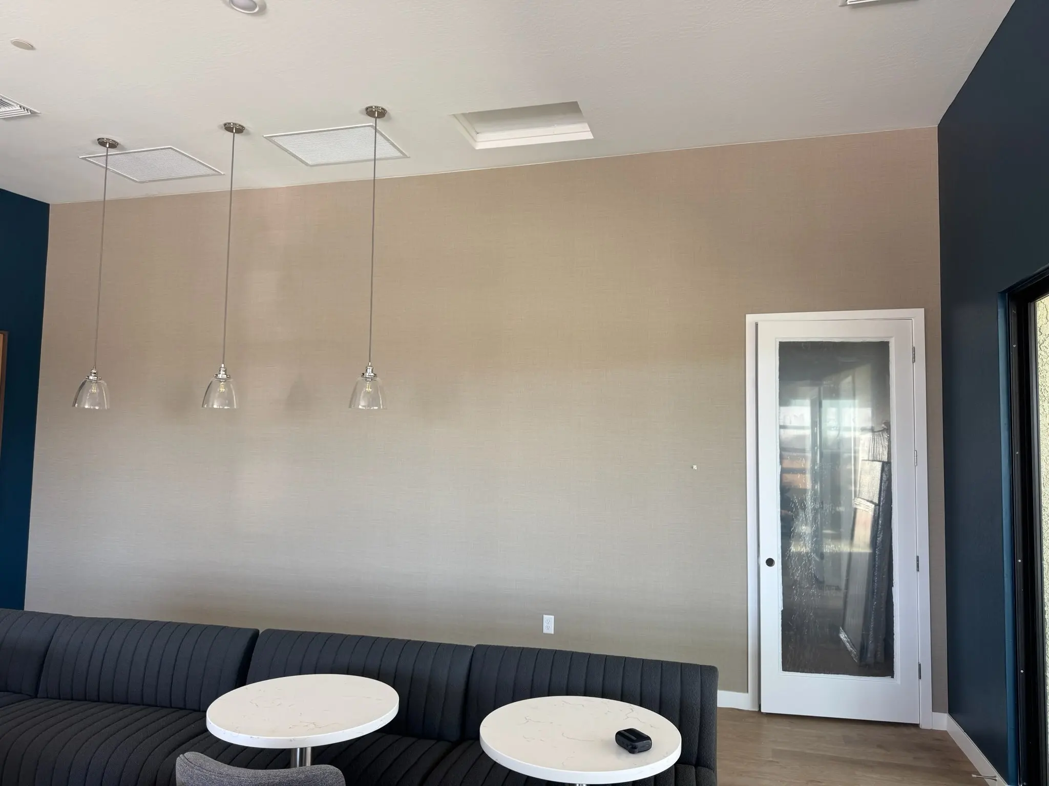 Hand-trimmed wallpaper edge along ceiling and trim